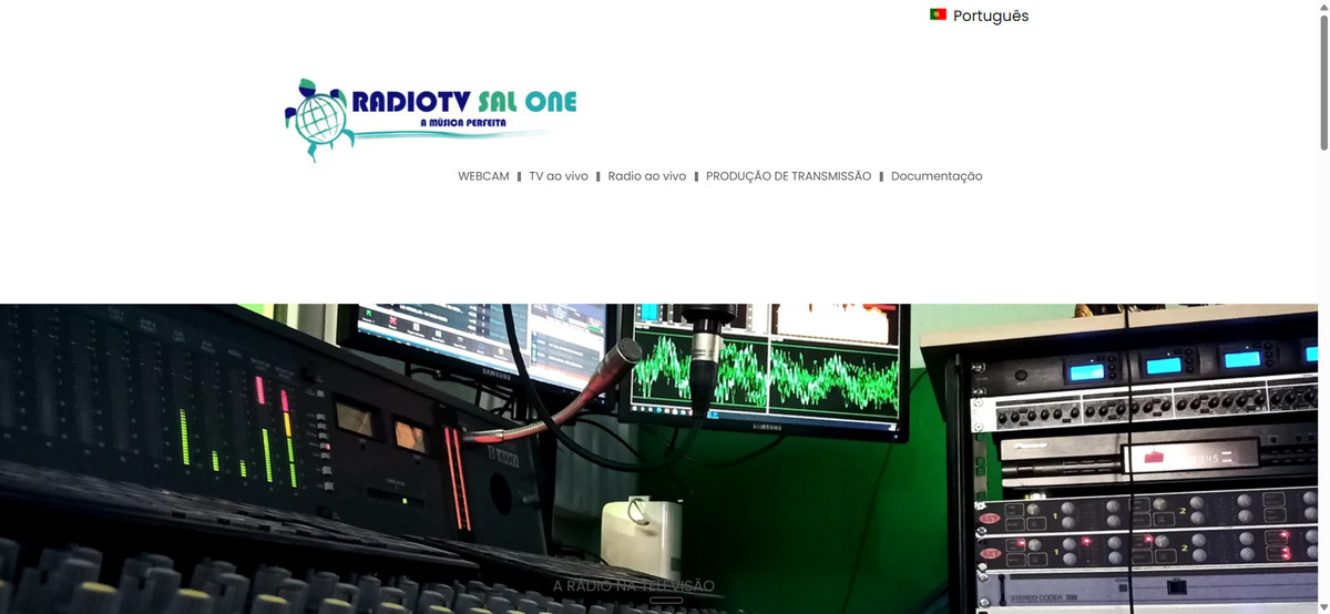 Radio studio equipment with audio meters, waveform displays, and control panels in a green-lit booth.