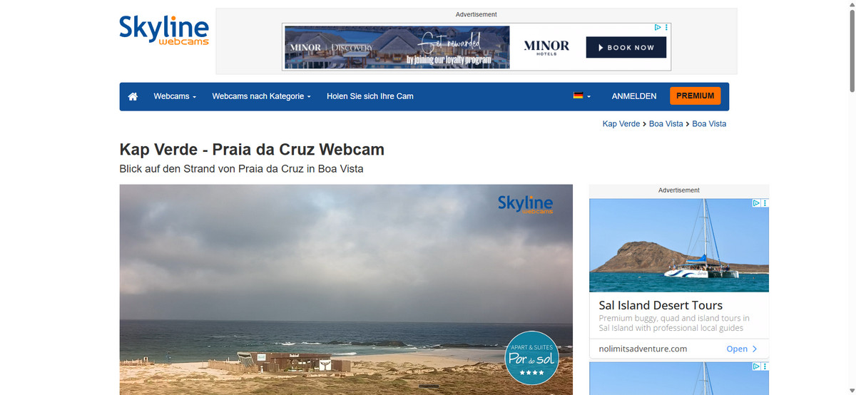 Skyline webcams webpage showing Kap Verde Praia da Cruz webcam view with ocean, beach, and advertisements.